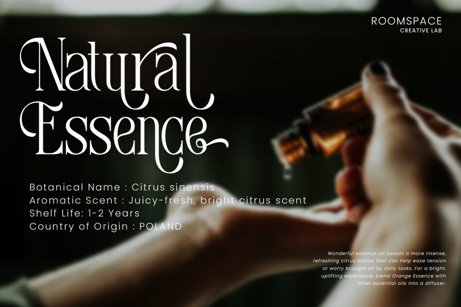Hand holding amber essential oil bottle with Natural Essence typography