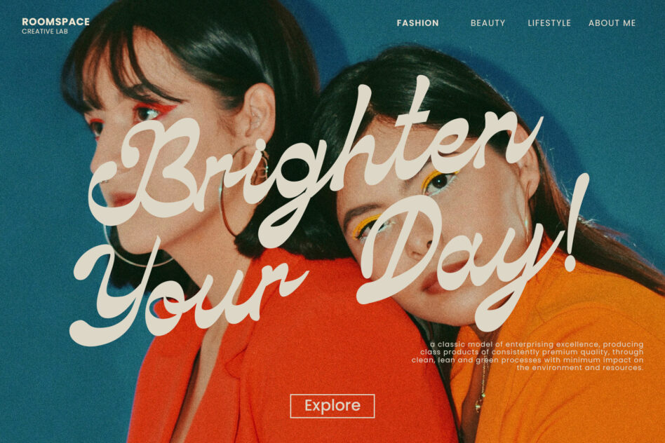 Two people with bold eye makeup wearing red orange shirts against teal background