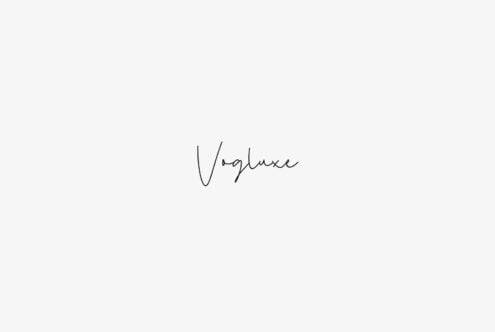 Vogluxe handwritten signature font displayed centered on cream background
