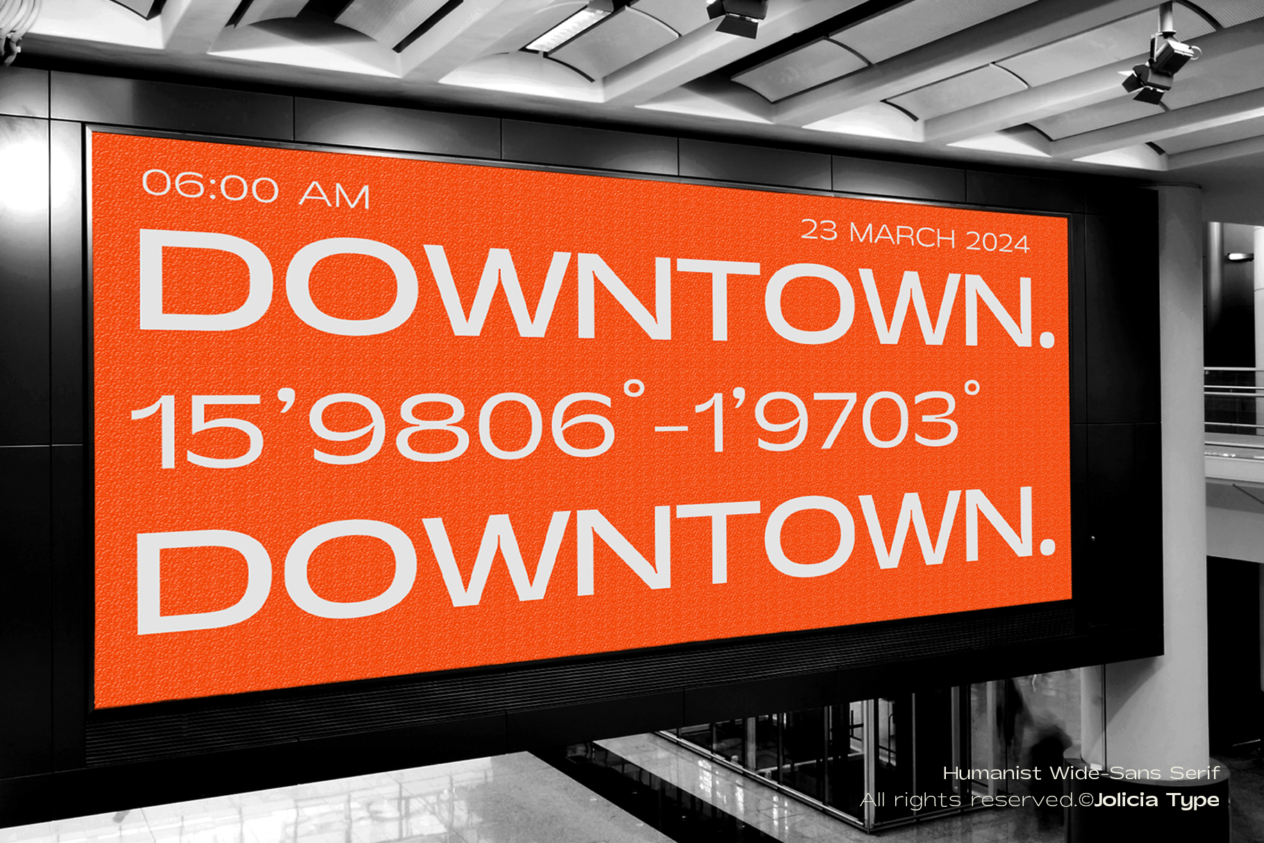 Large orange digital billboard displaying downtown event info with coordinates in sans serif type