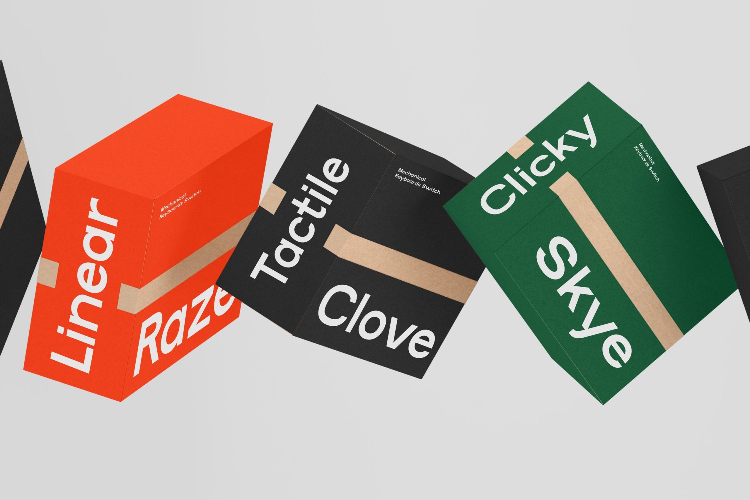 Three tilted product boxes in red, black, green with white sans serif typography on beige kraft tape