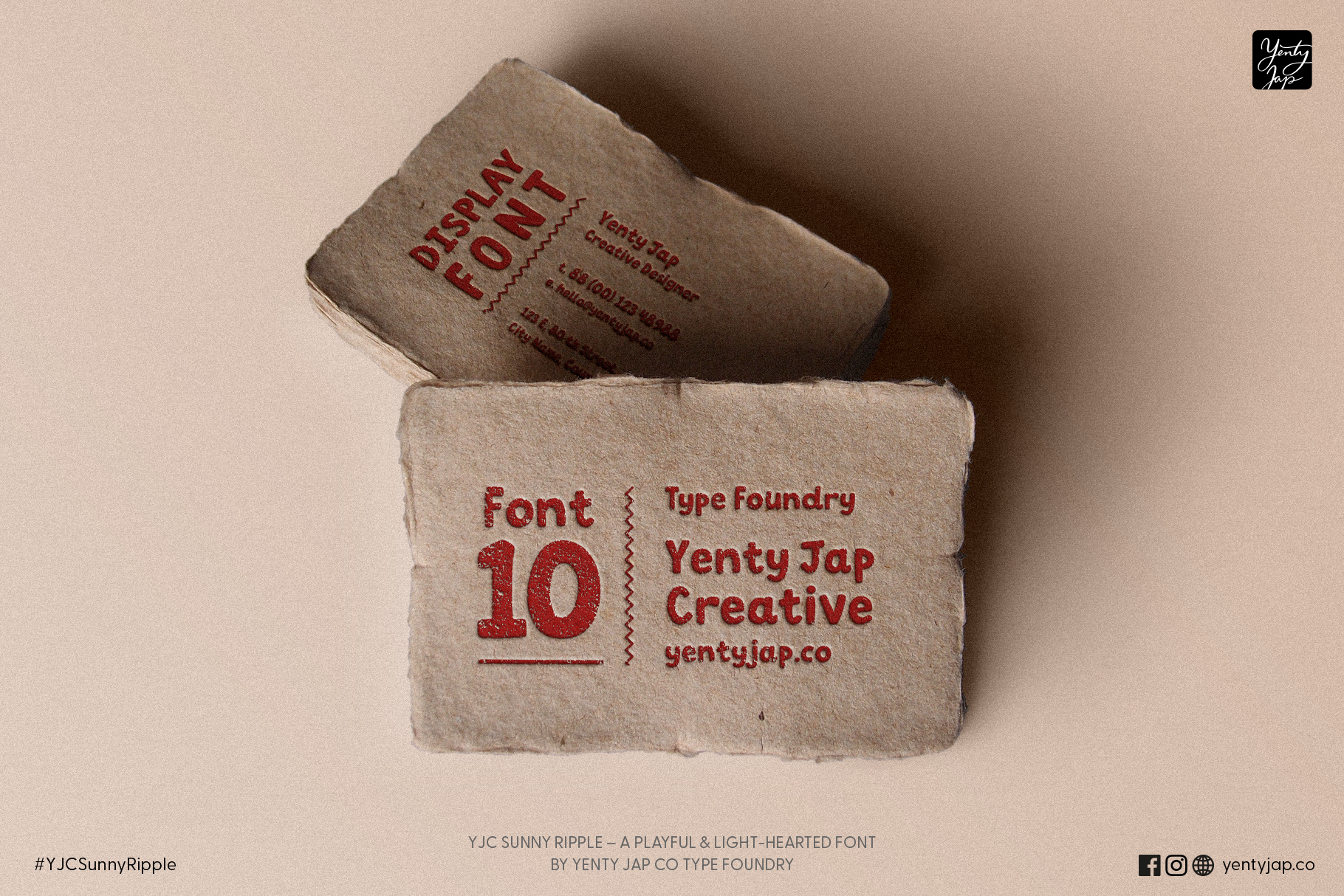 Stacked kraft business cards showing Display Font in red ink with contact details
