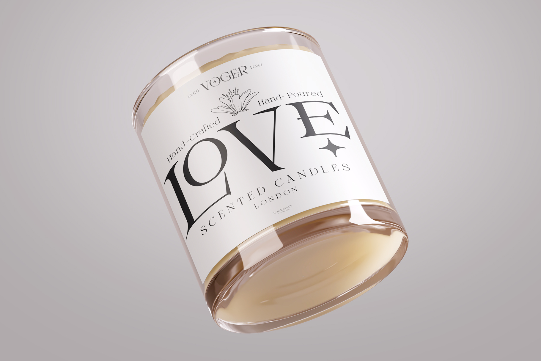 Clear glass candle jar with white label, gold accents, cream-colored wax inside