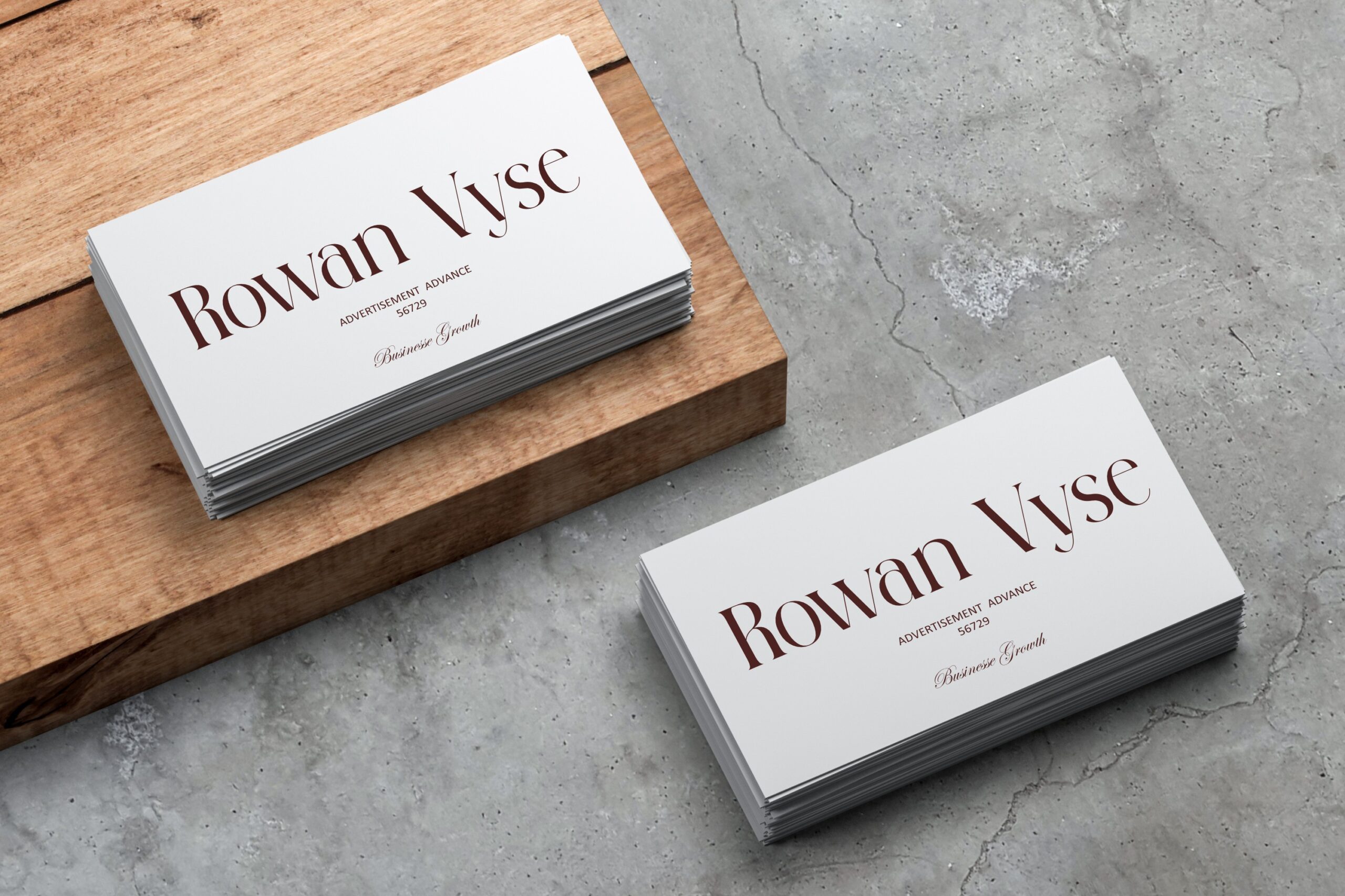 Business cards mockup stacked on wood concrete showing Rowan Vyse branding