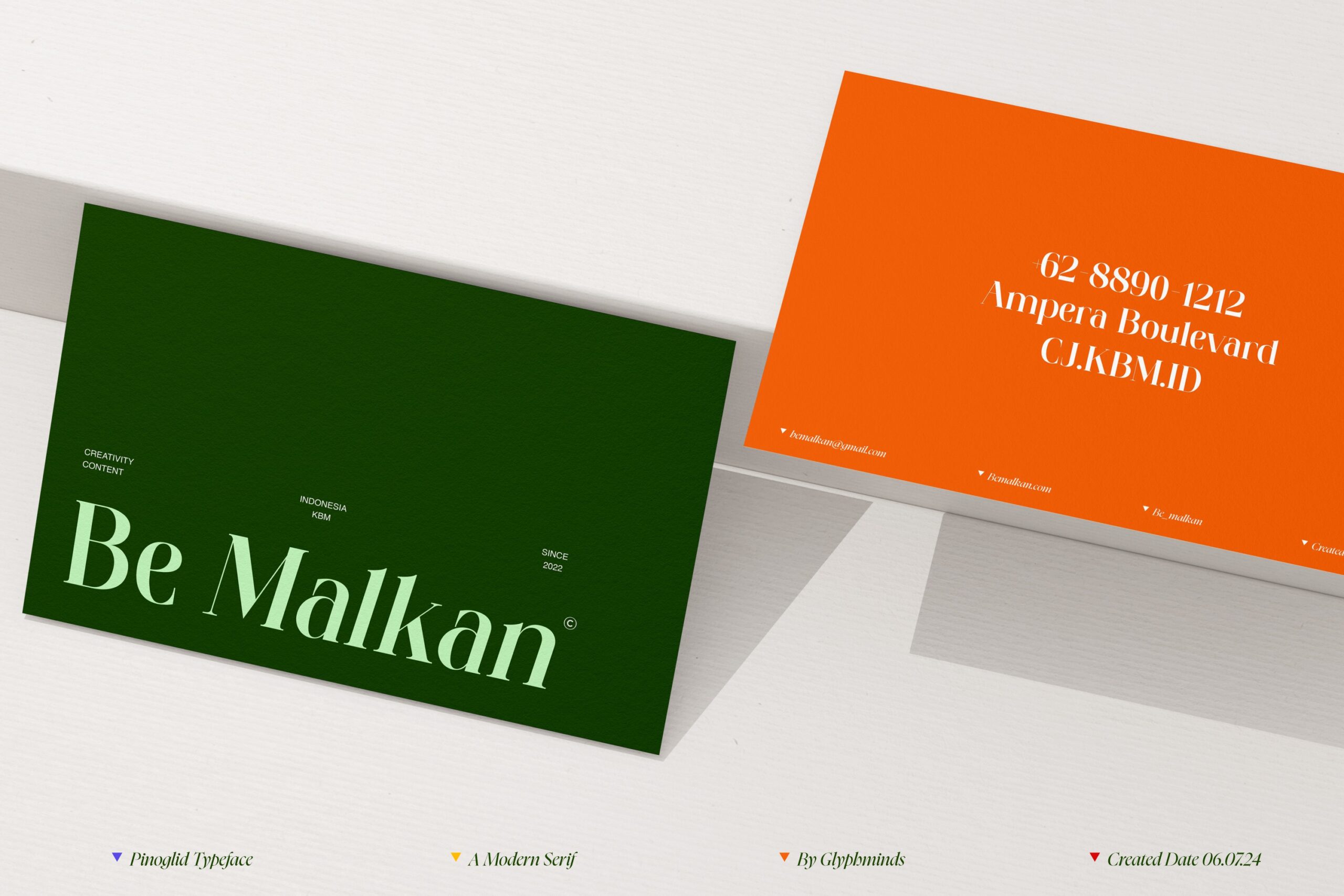 Business card mockup showing Pinoglid font in green orange colors
