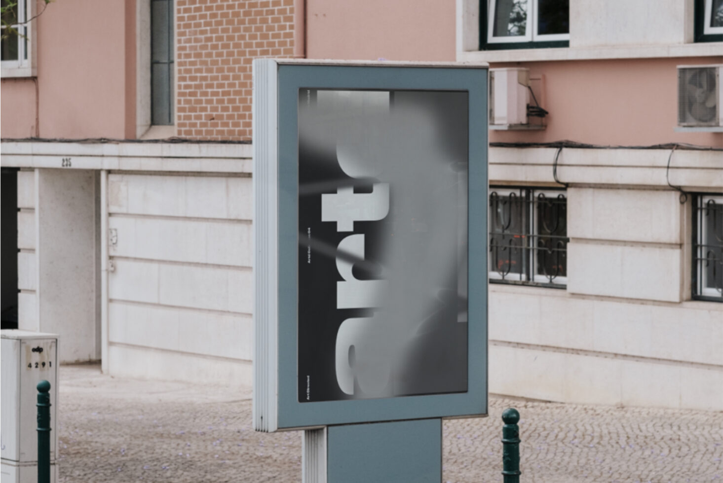 Street poster mockup on blue display case with geometric letterforms in urban setting