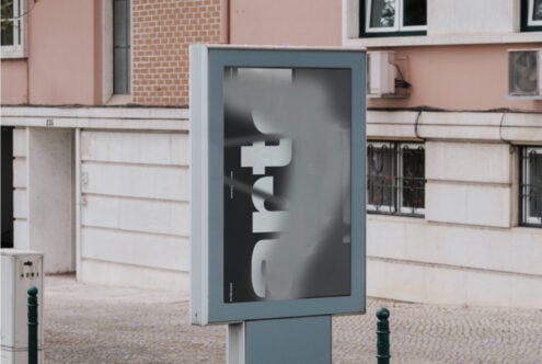 Street poster mockup on blue display case with geometric letterforms in urban setting