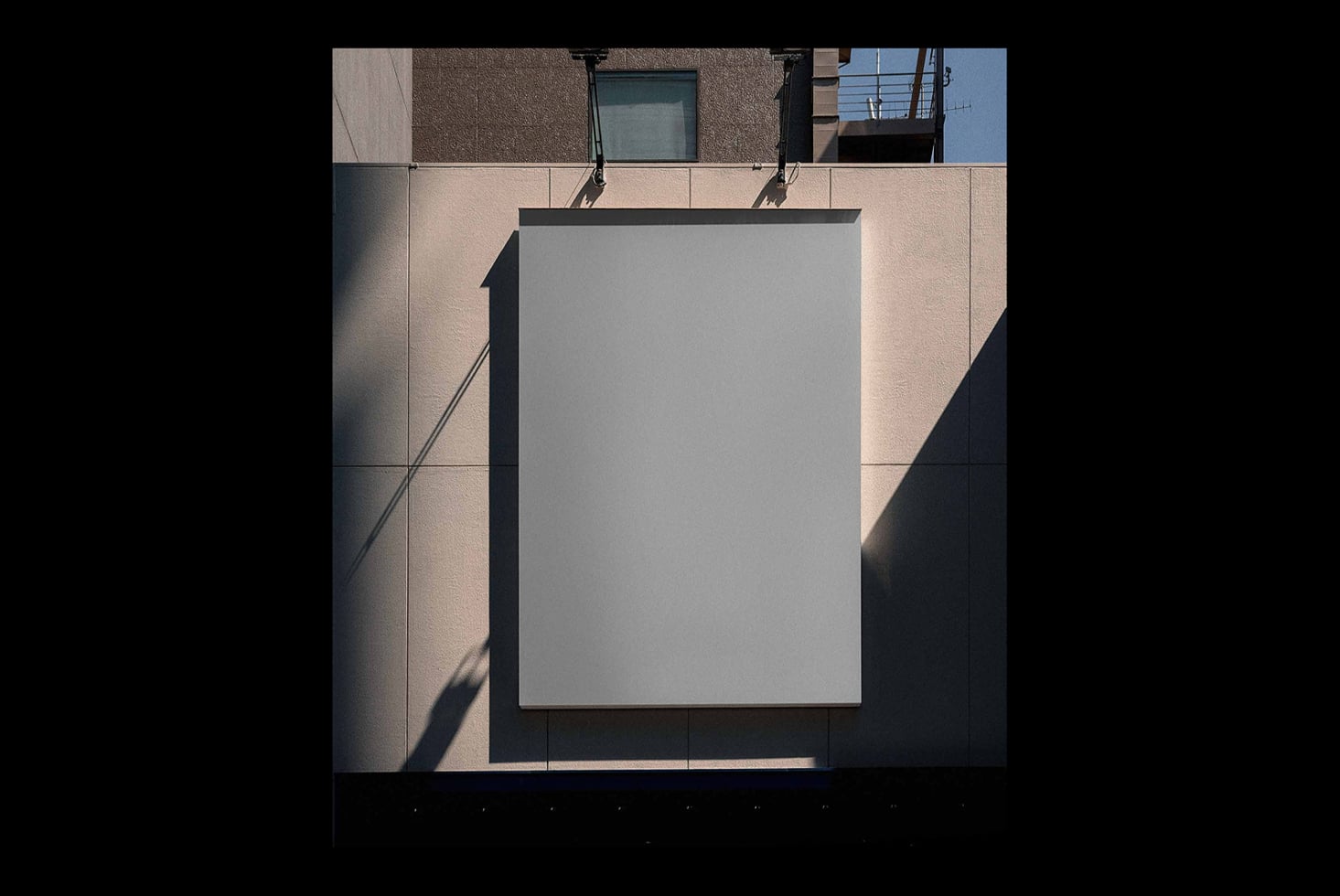 Blank poster mockup on concrete building facade with sharp shadow overlay