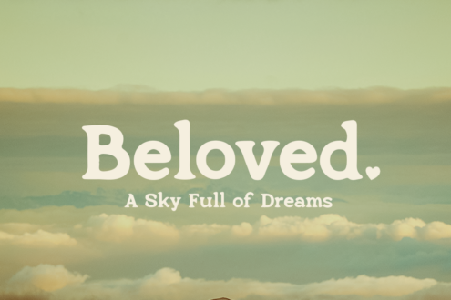 Beloved serif font over soft cloud sky gradient in cream tones