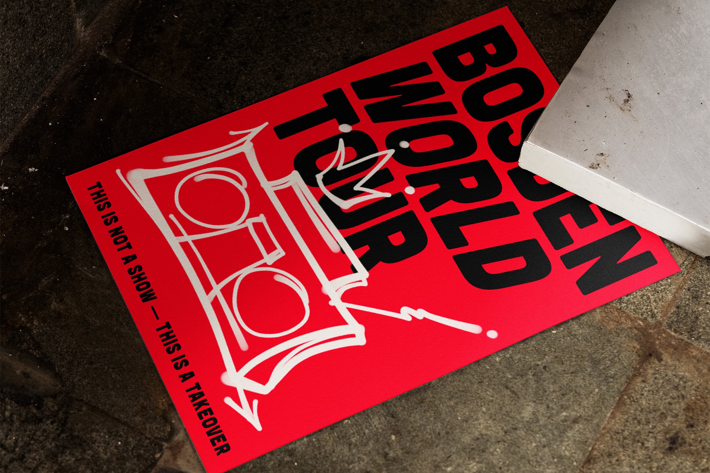 Red poster mockup with bold black typography on pavement surface