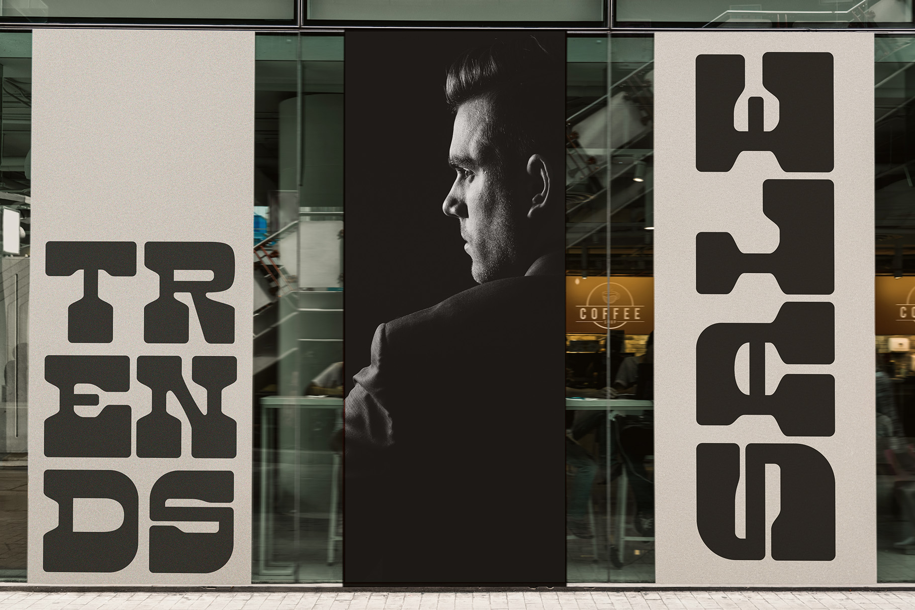 Store window display with large bold letters, man profile photo center panel