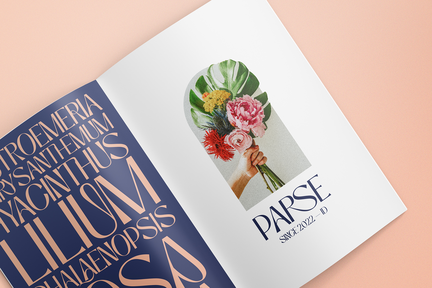 Magazine spread mockup with navy cover, florals in hand, peach background