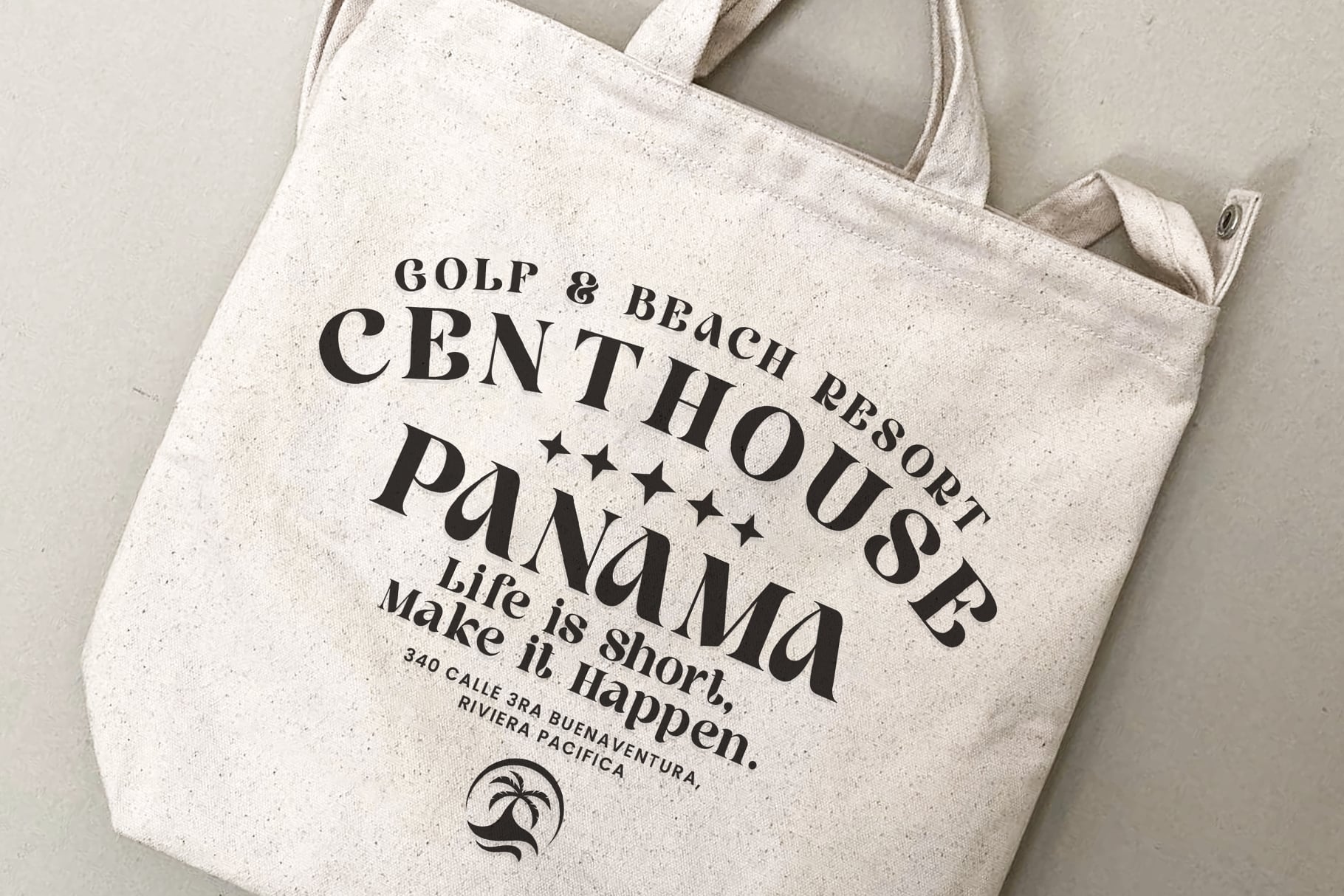Cream canvas tote bag with black text reading golf, beach resort, panamá