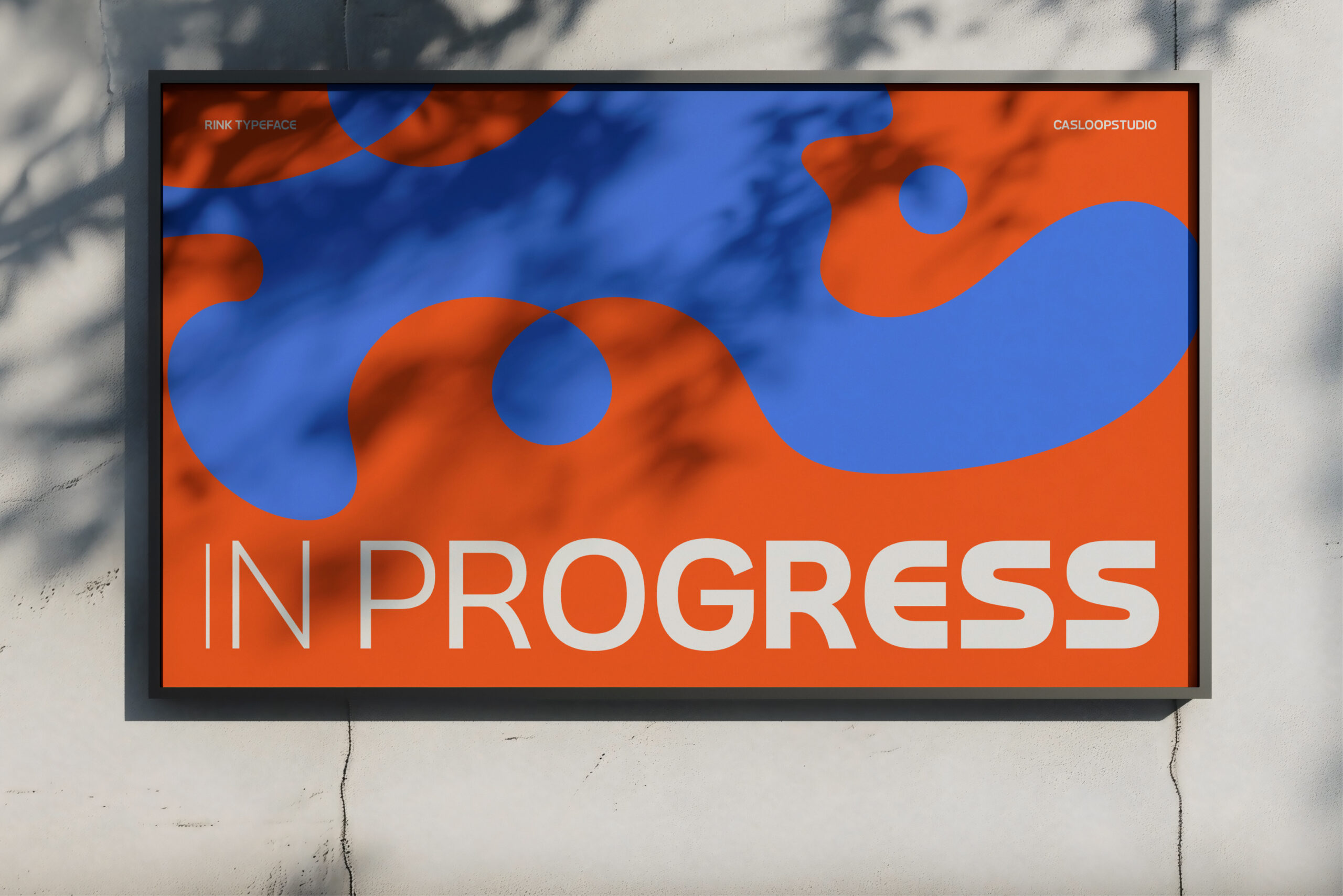 Digital billboard displaying IN PROGRESS text with flowing blue orange shapes
