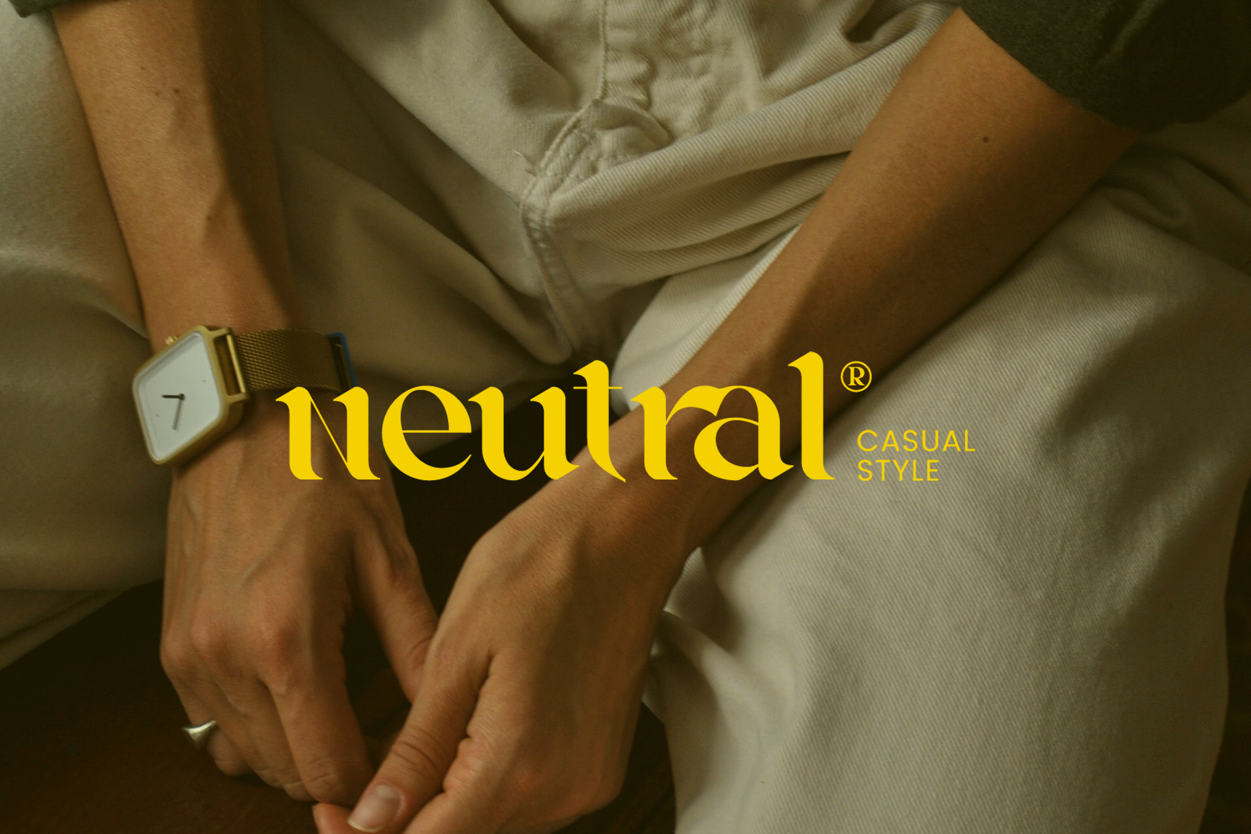 Two people wearing neutral beige clothing with Neutral brand logo on wrist watch