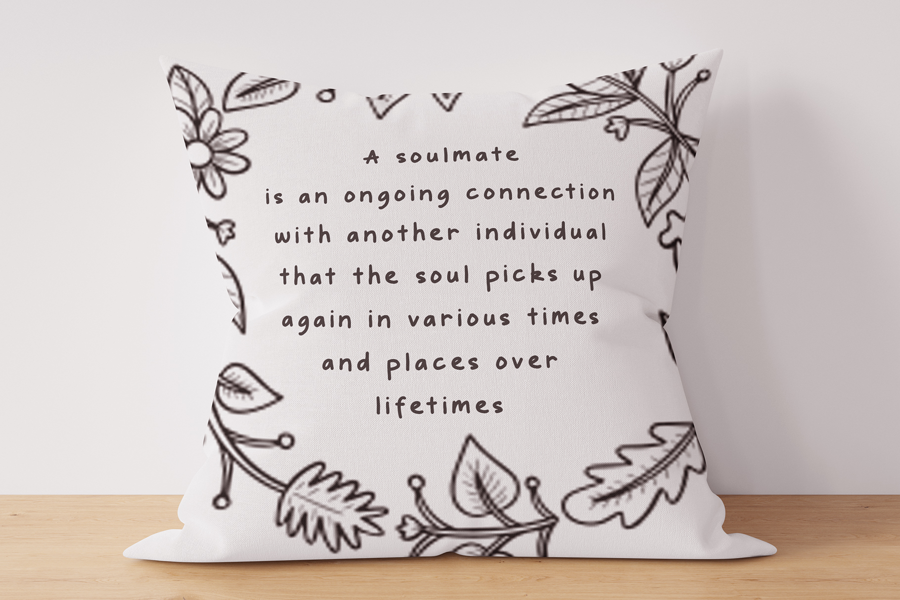 Pillow mockup with soulmate quote surrounded by botanical line drawings