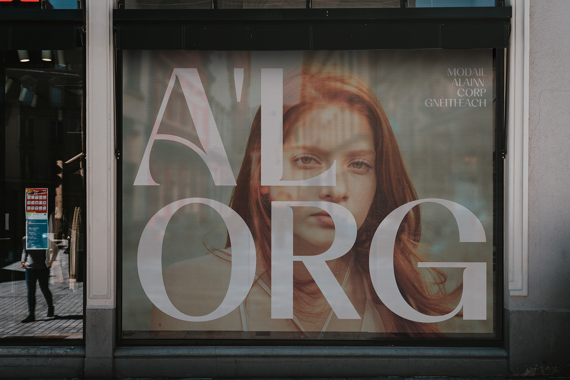 Window display mockup with large serif typography overlaying portrait photography of woman with red hair