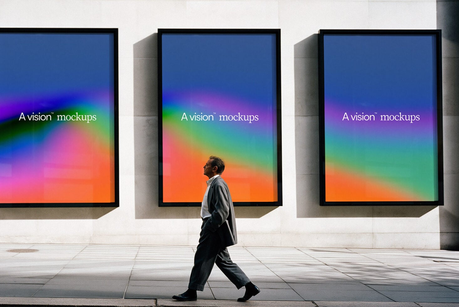Three framed displays with gradient overlays, person walking past