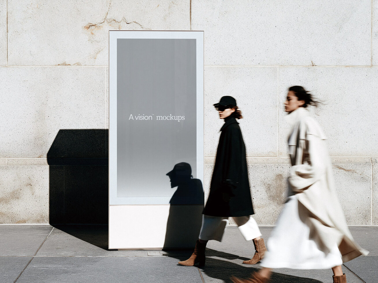 Tall kiosk with gray screen mockup on concrete tile, silhouettes of passersby in motion