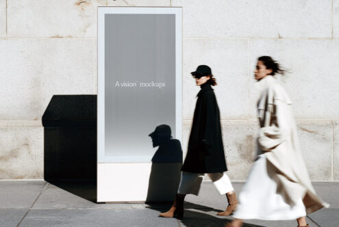 Street-level display kiosk with blank gray screen, urban setting with moving pedestrians
