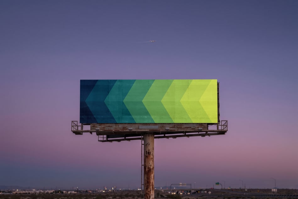 Vintage billboard displaying gradient chevron design teal to yellow