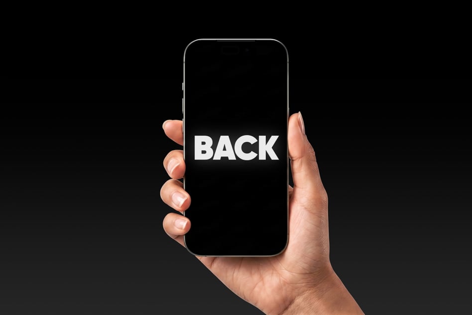 Hand holding phone showing BACK text on black screen