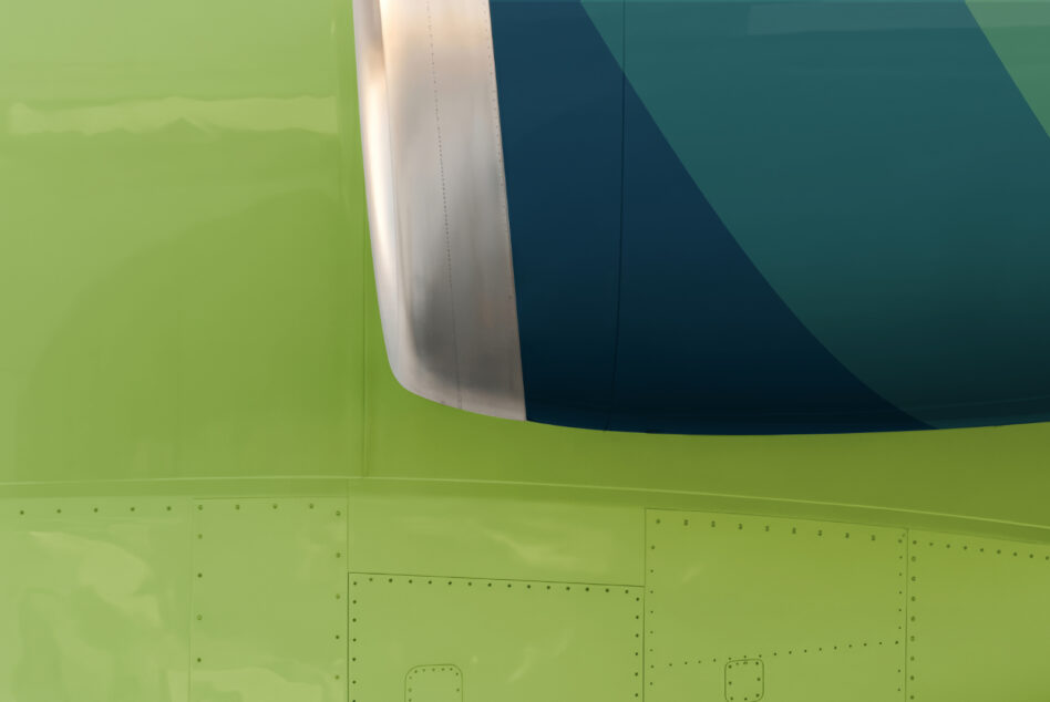 Bright lime green aircraft fuselage with teal chevron design on engine cowling