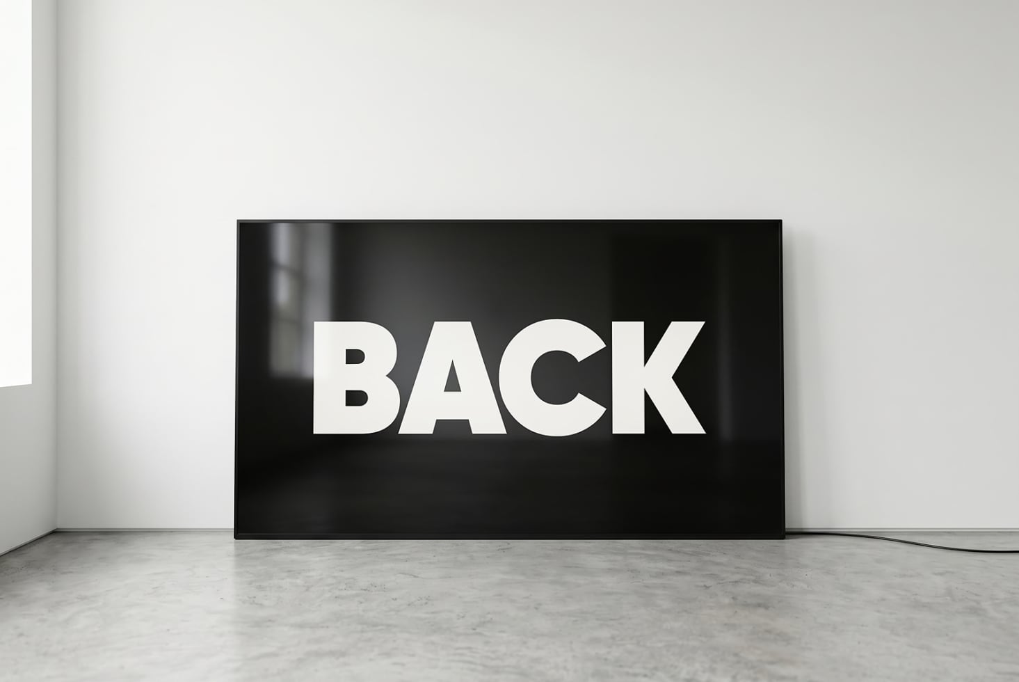 Horizontal flat screen displaying bold white BACK text on black