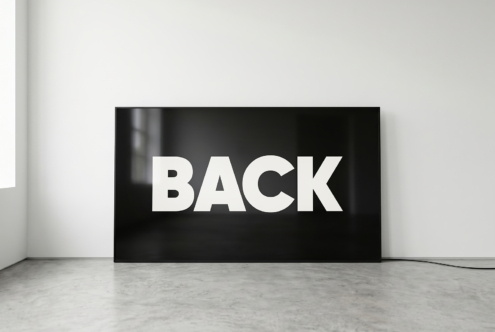 Horizontal flat screen displaying bold white BACK text on black