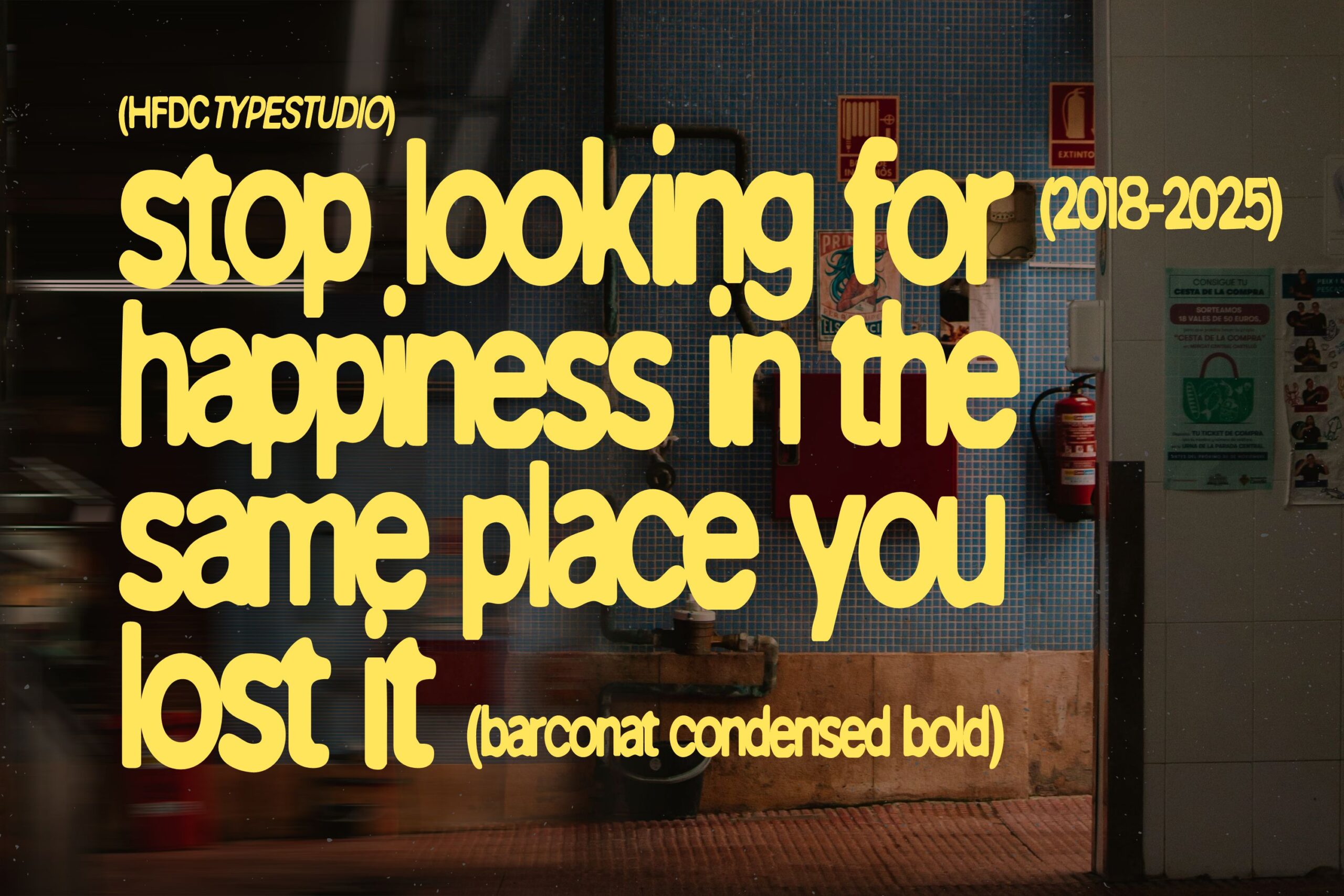 Yellow text on street storefront reading stop looking for happiness in same place you lost it