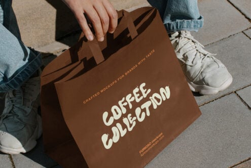 Brown paper bag mockup held up showing Coffee Collection branding in cream