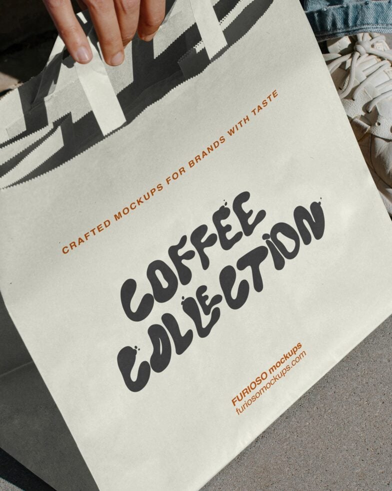 Hand holding natural tote bag with geometric stripe pattern, Coffee Collection in black