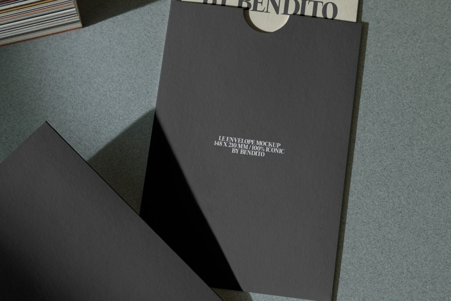 Dark envelope back view showing small serif text on matte finish surface