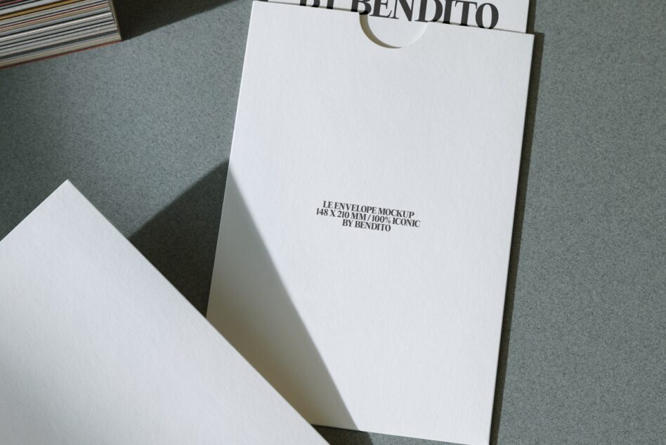 White envelope mockup 148x210mm on gray surface with minimal branding
