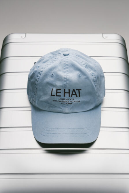 Light blue baseball cap with embroidered text on white striped background
