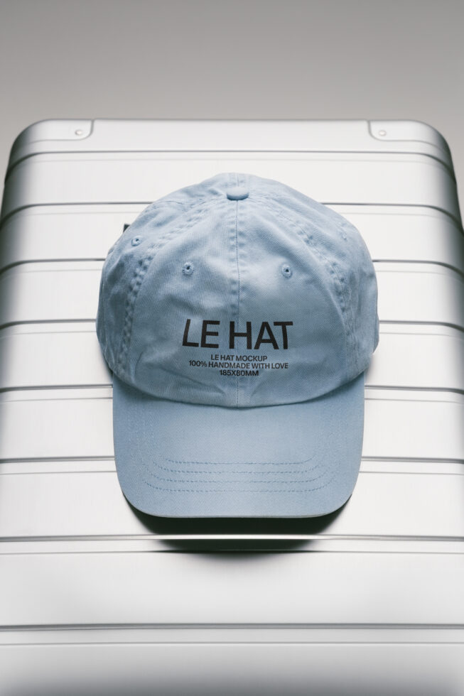 Light blue baseball cap with embroidered text on white striped background