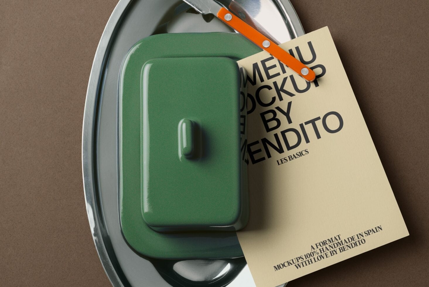 Green container on oval metal tray with orange knife, cream label attached