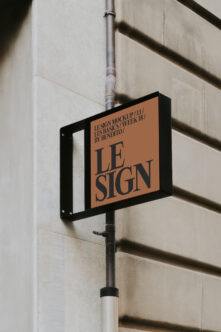 Street sign mockup mounted on pole with terracotta background, dark serif lettering