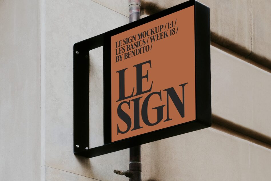 Orange street sign mockup with black frame mounted on beige wall