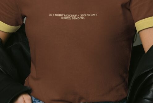 Close up of brown tee chest showing yellow trim at neckline, arms