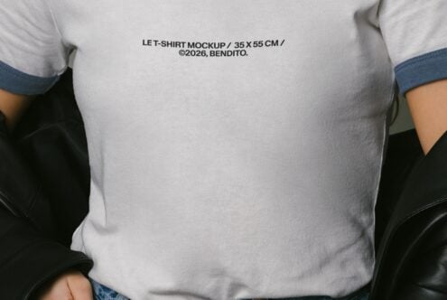 Close up of white tee chest showing navy trim at neckline, arms