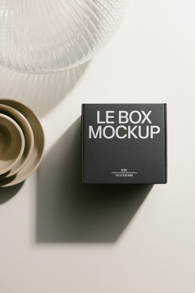 Charcoal box mockup photographed from above with cream bowls beside it