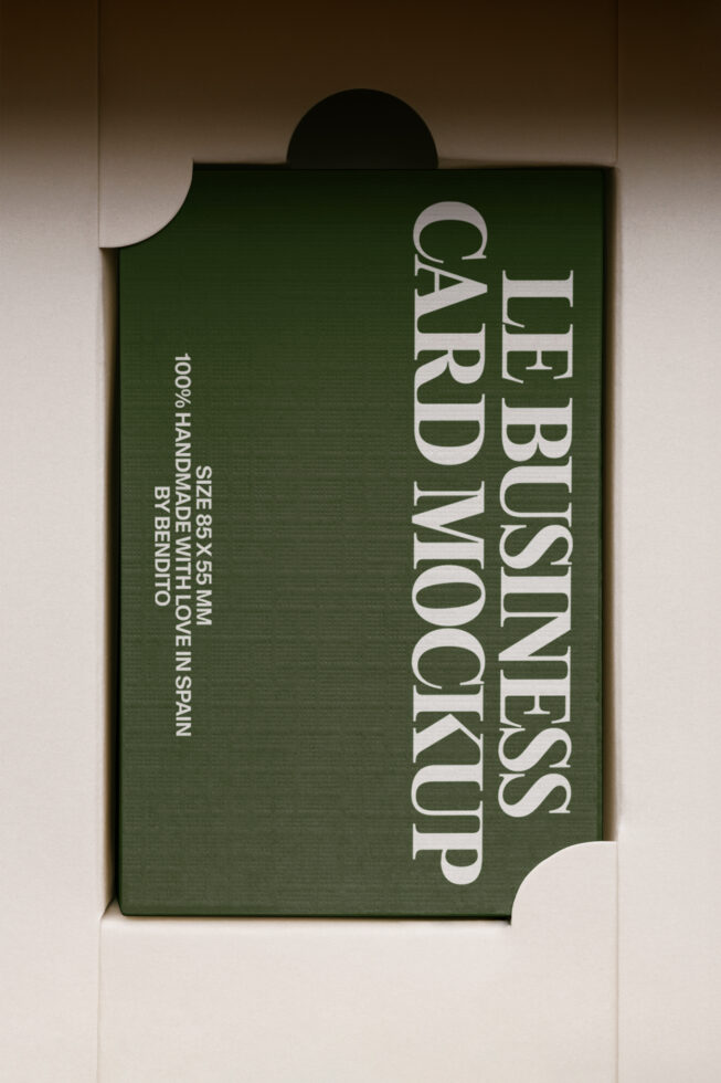Green business card mockup with white serif text on cream backdrop, top view
