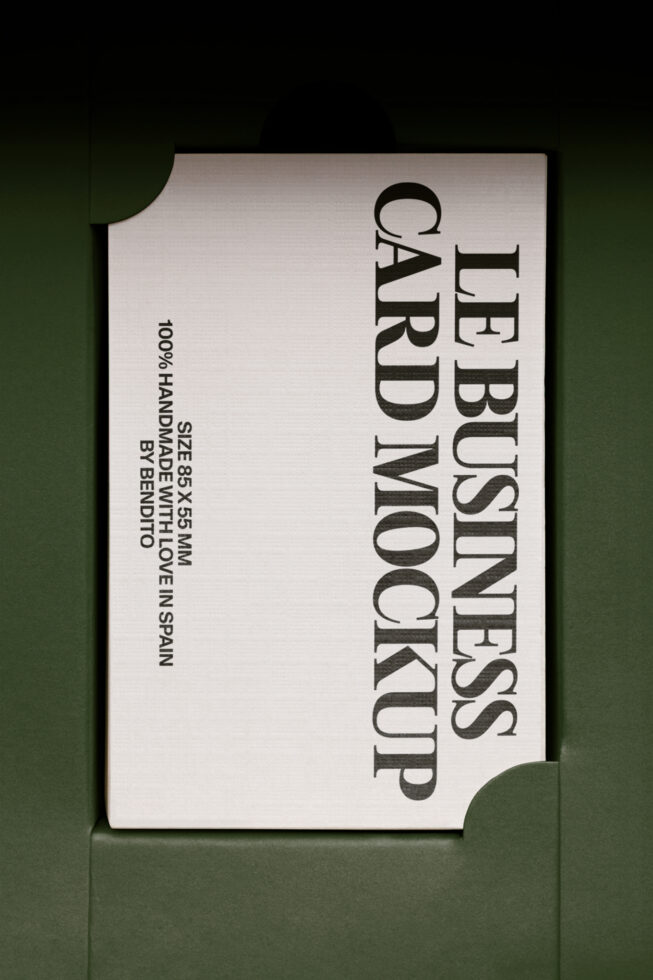 Off-white business card mockup with black serif text on green backdrop, top view