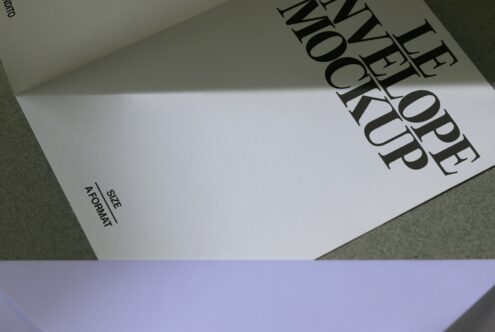 Opened A5 format brochure lying flat with bold serif typography visible