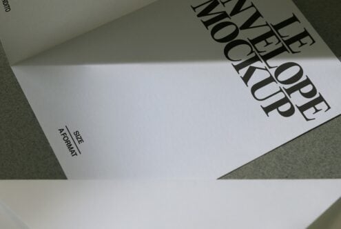 A5 sized paper mockup on surface showing layout with diagonal text treatment