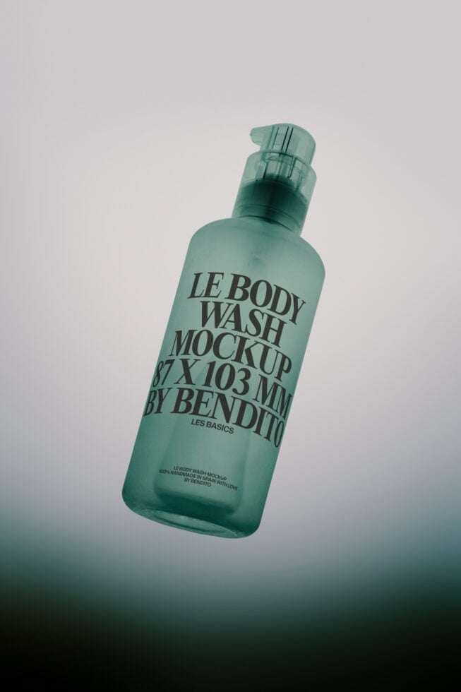 Frosted green body wash bottle tilted at angle with pump dispenser on neutral background