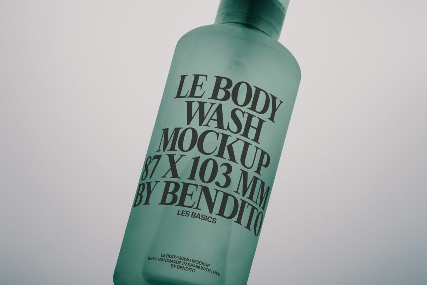 Frosted mint green body wash bottle angled with serif typography on label