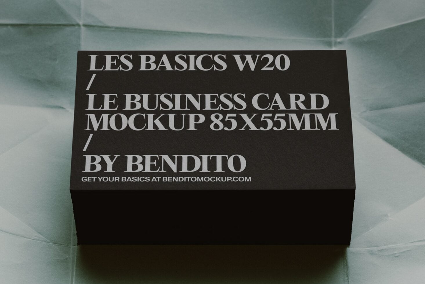 Black business card mockup 85x55mm sitting on translucent mint surface with shadow