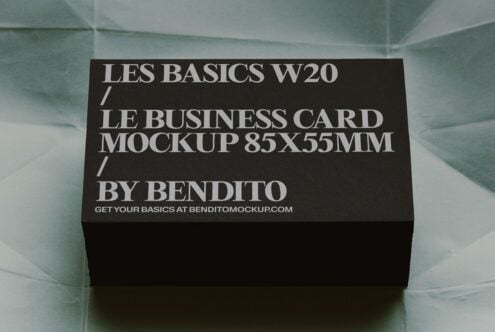 Black business card mockup 85x55mm sitting on translucent mint surface with shadow